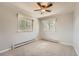 Empty bedroom with neutral carpet, two windows and a ceiling fan at 11410 W 72Nd Pl, Arvada, CO 80005