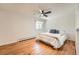 Bedroom featuring hardwood floors, a ceiling fan, and a window with a scenic view at 11410 W 72Nd Pl, Arvada, CO 80005