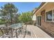 Outdoor deck featuring a table and chairs, overlooking a serene view at 11410 W 72Nd Pl, Arvada, CO 80005