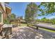 An open deck overlooking the landscaped backyard features wood benches and stairs to the yard below at 11410 W 72Nd Pl, Arvada, CO 80005