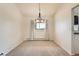 Bright dining room with plush carpet, modern lighting, and large window with natural light at 11410 W 72Nd Pl, Arvada, CO 80005