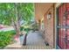 Cozy front porch with chairs, planter and brick exterior under covered entrance at 11410 W 72Nd Pl, Arvada, CO 80005