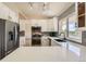 Modern kitchen featuring stainless steel appliances, white cabinets, quartz countertops, and a stylish backsplash at 11410 W 72Nd Pl, Arvada, CO 80005