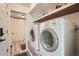 Convenient laundry room features a washer, dryer, and shelves at 11410 W 72Nd Pl, Arvada, CO 80005