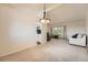 Bright living room with plush carpet, modern lighting, and ample natural light from the large window at 11410 W 72Nd Pl, Arvada, CO 80005