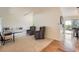 Spacious living room with plush carpet, contemporary furniture, and access to the kitchen and outdoor patio at 11410 W 72Nd Pl, Arvada, CO 80005