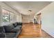Inviting living room featuring hardwood floors and a comfortable gray sofa at 11410 W 72Nd Pl, Arvada, CO 80005