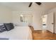 Spacious main bedroom with hardwood floors, closet, and access to the bathroom at 11410 W 72Nd Pl, Arvada, CO 80005