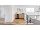 Bar area with modern cabinets, stainless steel appliances, and hardwood floors at 1683 N Zenobia St, Denver, CO 80204