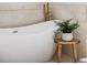 Modern soaking tub with marble surround and stylish gold fixtures at 1683 N Zenobia St, Denver, CO 80204