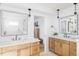 Beautiful primary bathroom with double vanities, designer mirrors, and modern fixtures at 1683 N Zenobia St, Denver, CO 80204