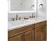 Double sink vanity with lighted mirror and modern bronze fixtures at 1683 N Zenobia St, Denver, CO 80204