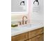 Stylish vanity with quartz countertop, bronze faucet, and towel bar at 1683 N Zenobia St, Denver, CO 80204
