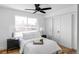 Comfortable bedroom featuring a large window, hardwood floors, and ceiling fan at 1683 N Zenobia St, Denver, CO 80204