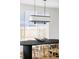 Close up on modern dining table with designer lighting, hardwood floors, and natural light at 1683 N Zenobia St, Denver, CO 80204