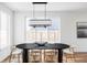 Elegant dining area with a modern black table and stylish chandelier under the window at 1683 N Zenobia St, Denver, CO 80204