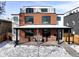Exterior elevation of home with covered porch, brick facade, and rooftop deck at 1683 N Zenobia St, Denver, CO 80204