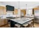Gourmet kitchen with stainless steel appliances, custom cabinetry, and a large center island at 1683 N Zenobia St, Denver, CO 80204