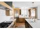 Bright kitchen with stainless steel appliances, custom cabinetry, and hardwood flooring at 1683 N Zenobia St, Denver, CO 80204