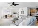 Bright living space features a large sectional, hardwood floors, and modern light fixtures at 1683 N Zenobia St, Denver, CO 80204