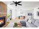 Bright living room featuring a fireplace, hardwood floors, and a comfortable gray sectional sofa at 1683 N Zenobia St, Denver, CO 80204