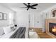 Cozy main bedroom with a modern fireplace, hardwood floors, and neutral decor at 1683 N Zenobia St, Denver, CO 80204