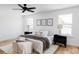 Bright main bedroom with plush bedding, side tables, and lots of natural light at 1683 N Zenobia St, Denver, CO 80204
