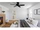 Stylish main bedroom with fireplace, access to a private ensuite, and light hardwood floors at 1683 N Zenobia St, Denver, CO 80204