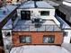 Rooftop deck featuring seating with black metal railing and brick exterior at 1683 N Zenobia St, Denver, CO 80204