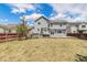 Large backyard with well-kept lawn, patio, BBQ, and seating, all secured by a wooden fence at 821 S 34Th Ave, Brighton, CO 80601