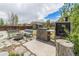 Outdoor patio with custom stone barbecue, fire pit, and bench seating perfect for entertaining guests at 821 S 34Th Ave, Brighton, CO 80601