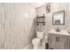 Stylish bathroom featuring shiplap walls, a modern vanity, and industrial-chic lighting at 821 S 34Th Ave, Brighton, CO 80601