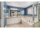 Bright bathroom featuring dual sinks, a soaking tub, and separate shower stall at 821 S 34Th Ave, Brighton, CO 80601