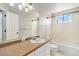 Bright bathroom featuring a vanity, shower over tub and a window at 821 S 34Th Ave, Brighton, CO 80601