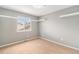 Cozy bedroom with neutral walls, carpet, and window offering natural light at 821 S 34Th Ave, Brighton, CO 80601