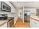Modern kitchen with stainless steel appliances, hardwood floors, and white cabinets at 821 S 34Th Ave, Brighton, CO 80601