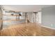 Open-concept living room with hardwood floors leading to the kitchen and staircase at 821 S 34Th Ave, Brighton, CO 80601