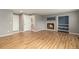 Spacious living room with wood flooring, fireplace, and open doorway to a utility room at 821 S 34Th Ave, Brighton, CO 80601