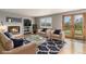 Comfortable living room with a fireplace, modern furniture, and a glass door leading to the yard at 821 S 34Th Ave, Brighton, CO 80601