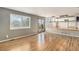 Open-concept living room boasts hardwood floors and large windows for natural light near the kitchen at 821 S 34Th Ave, Brighton, CO 80601