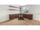 Carpeted loft space featuring built-in desk, shelving, and a window with natural light at 821 S 34Th Ave, Brighton, CO 80601