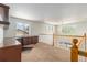 Loft area with built-in desk and cabinetry, natural light, and view of the main floor at 821 S 34Th Ave, Brighton, CO 80601