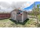 Exterior view of shed with white trim, a grey body, a bird house, and a lush lawn at 821 S 34Th Ave, Brighton, CO 80601