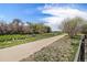 Scenic walking path surrounded by lush greenery and trees for a peaceful outdoor experience at 821 S 34Th Ave, Brighton, CO 80601