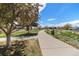 Well-maintained walking path through a picturesque neighborhood, lined with trees and landscaping at 821 S 34Th Ave, Brighton, CO 80601