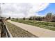 Paved walking path lined with greenery and trees, ideal for outdoor recreation and a healthy lifestyle at 821 S 34Th Ave, Brighton, CO 80601