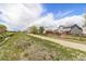 Scenic walking path with lush greenery, adjacent to a home and a tranquil stream, perfect for leisurely strolls at 821 S 34Th Ave, Brighton, CO 80601