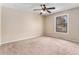 Simple bedroom with carpet, neutral tones, and a window for natural light at 2891 S Vaughn Way, Aurora, CO 80014