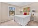 Bright bedroom featuring neutral walls, carpet, and a large window overlooking the outdoors at 2891 S Vaughn Way, Aurora, CO 80014