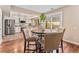 Cozy dining area with wood floors, table with chairs, and kitchen in the background at 2891 S Vaughn Way, Aurora, CO 80014